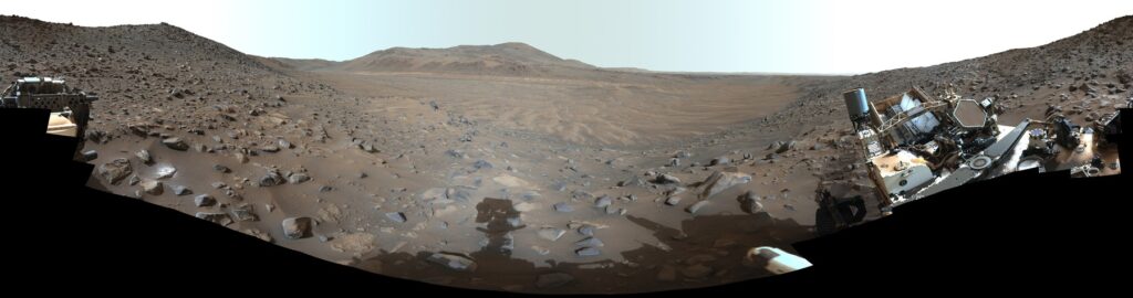 Panorama of a dusty, dry river channel on the rim of Jezero Crater on Mars, seen by Perseverance