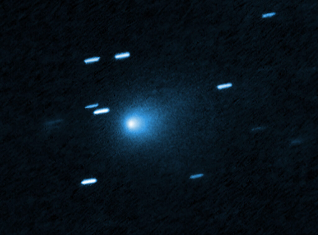 Hubble image of interstellar comet 3I/ATLAS, a fuzzy teardrop of dust against streaked background stars